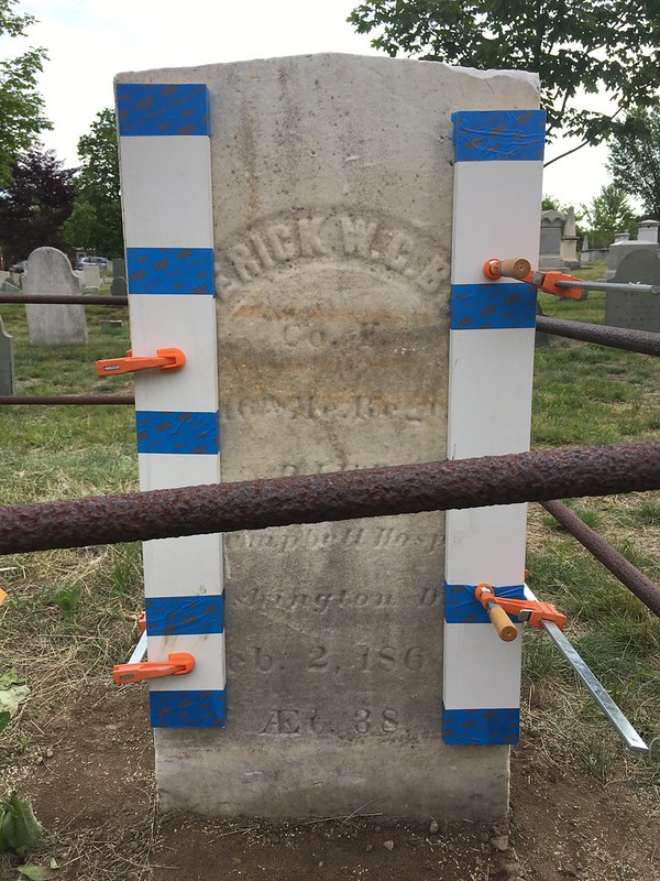 marble headstone with clamps on each side