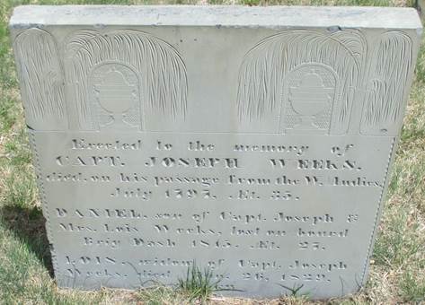 Rectangular slate grave marker, set in the grass, carved with 2 separate urn and willow motifs for Capt. Joseph Weeks, son Daniel, and widow Lois. Text transcription under Figure 6 of this paper.