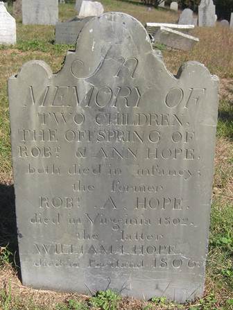 Slate grave marker inscribed with fancy lettering for the Hopes. The top of the marker is decorated with a rounded top sloping to 1 smaller bump on each side of it.