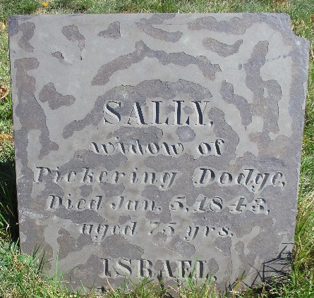 old slate grave marker for Sally and Israel Dodge that is wearing away and purplish