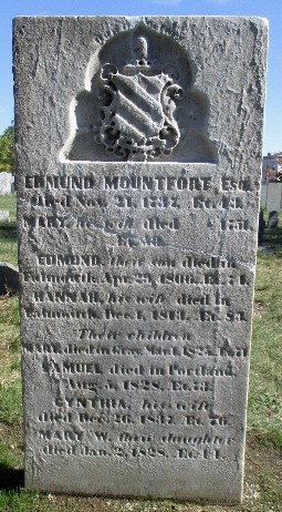 detail of an old marble gravestone with a family crest