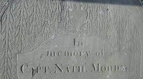 detail of an old slate gravestone in Eastern Cemetery carved with In memory of Capt. Nathl Moody and outline of a tiny urn above it surrounded by leafy tree branches