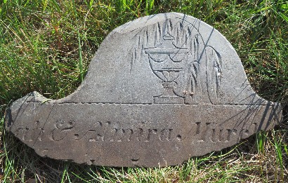 piece of an old slate gravestone carved with an urn and willow