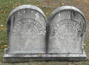 old dirty marble rounded headstones on a granite rectangle base for Mary E. Briggs and Clark E. Cole